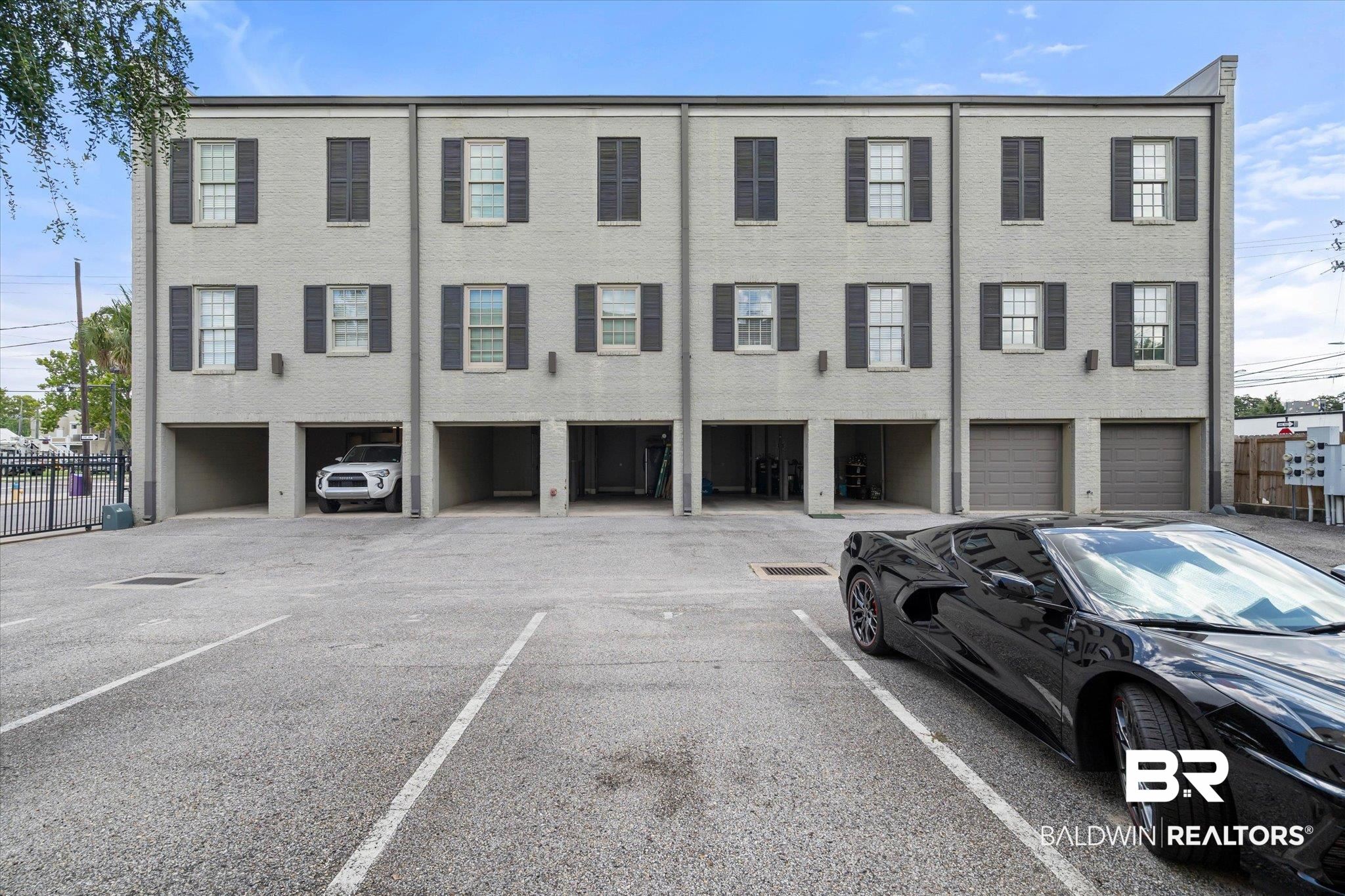 701 Dauphin Street, Unit A Mobile, AL 36602 - Photo 29 of 31 Multi-story brick facade featuring multiple window openings with dark shutters
