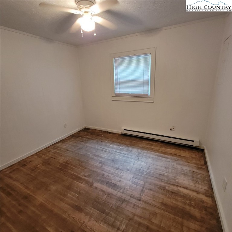 151 Rogers Drive Boone, NC 28607 - Photo 11 of 15 an empty room with a chandelier fan and windows