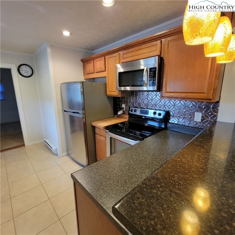 151 Rogers Drive Boone, NC 28607 - Photo 5 of 15 a kitchen with stainless steel appliances granite countertop a sink and a stove