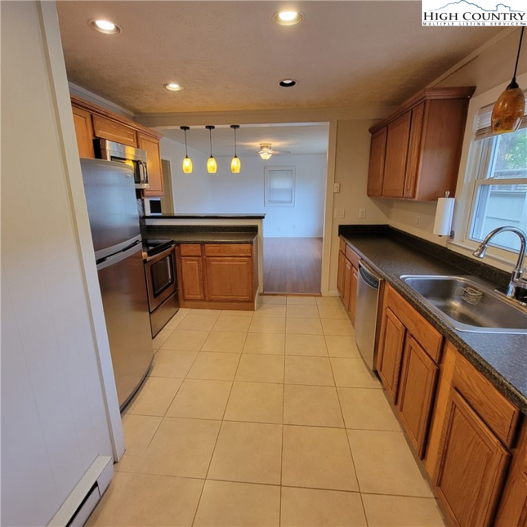 151 Rogers Drive Boone, NC 28607 - Photo 6 of 15 a kitchen with stainless steel appliances a sink a stove a refrigerator a microwave oven and cabinets
