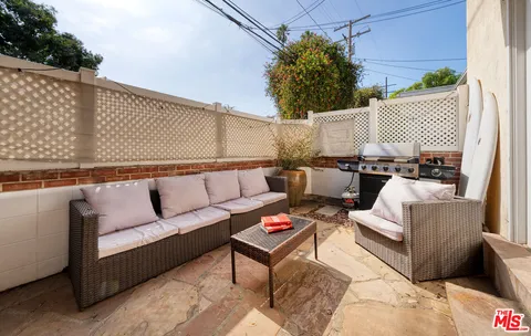 a roof deck with couches and potted plant