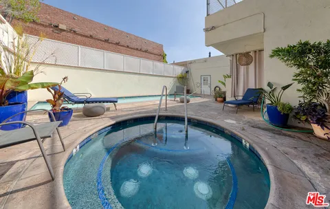 a view of a patio with table and chairs potted plants
