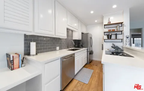 a kitchen that has a sink and a stove in it