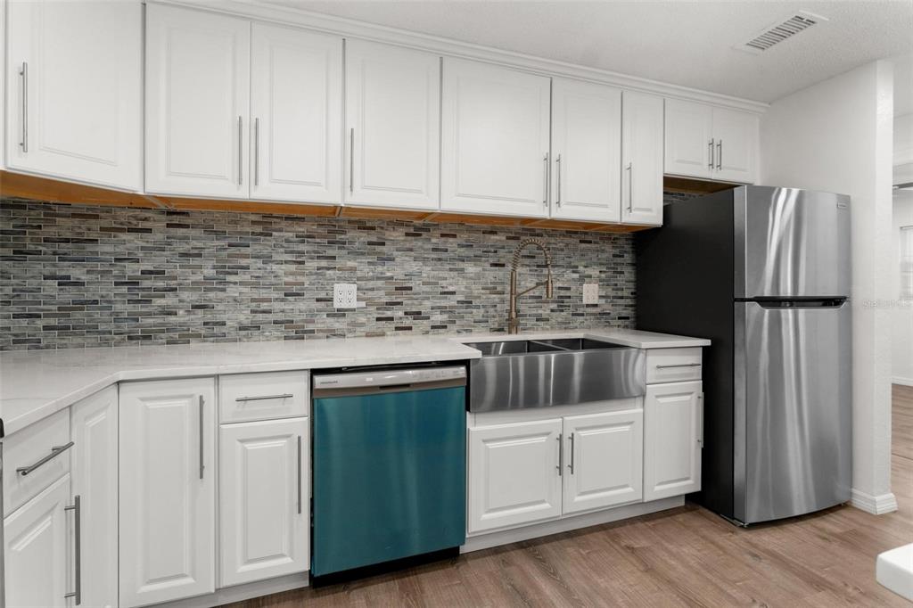2203 Nottingham Road South Daytona, FL 32119 - Photo 12 of 40 a kitchen with granite countertop white cabinets and stainless steel appliances