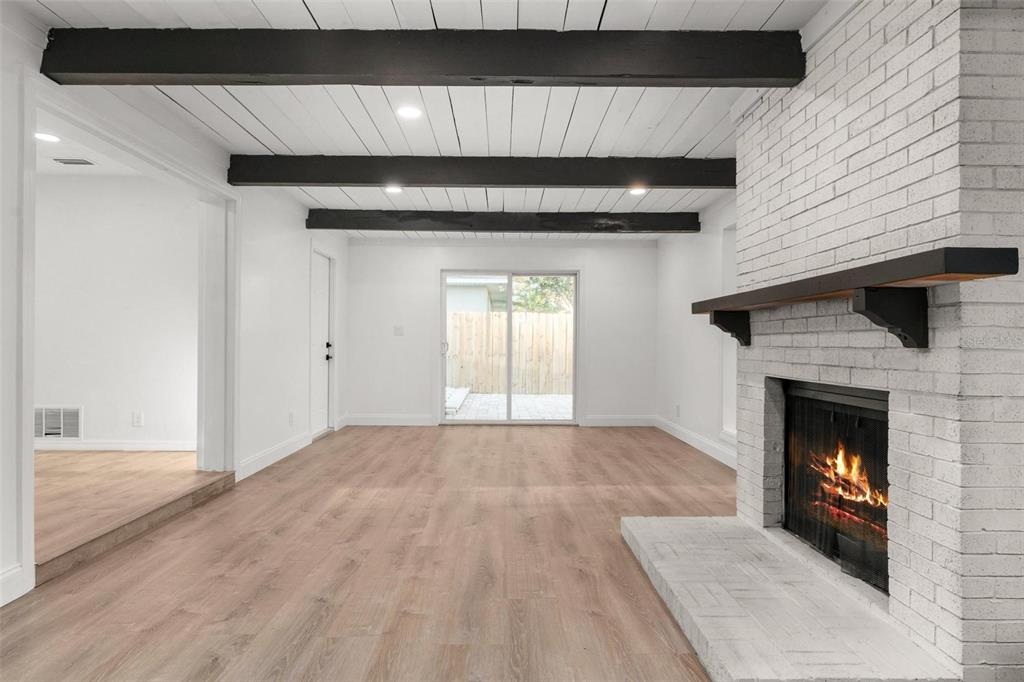 2203 Nottingham Road South Daytona, FL 32119 - Photo 18 of 40 a view of an empty room with wooden floor and a fireplace