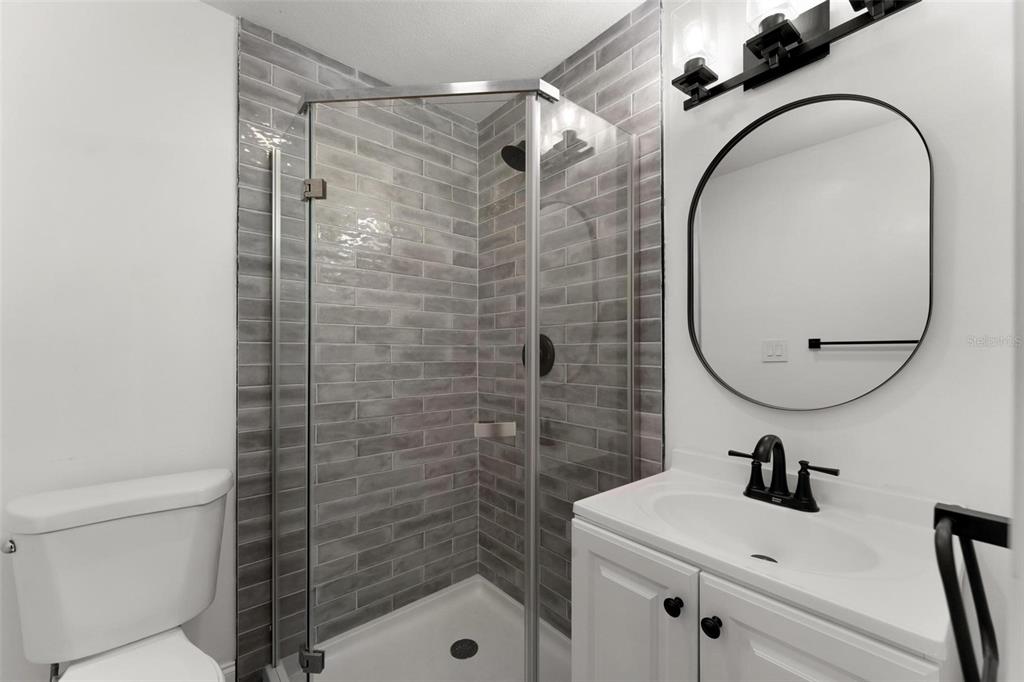 2203 Nottingham Road South Daytona, FL 32119 - Photo 25 of 40 a bathroom with a sink a mirror and a shower