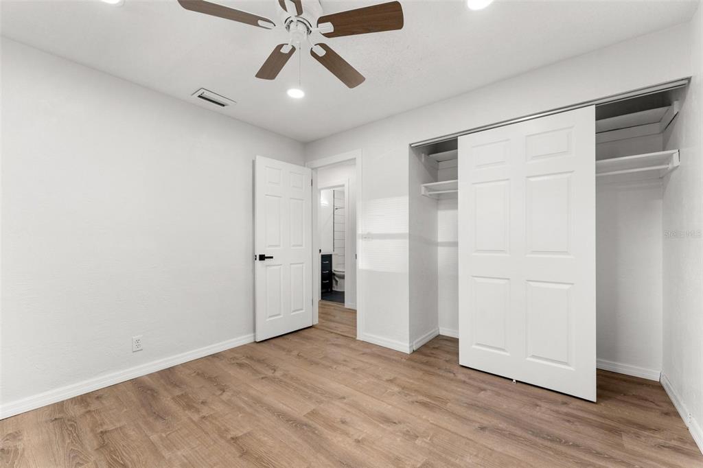 2203 Nottingham Road South Daytona, FL 32119 - Photo 31 of 40 an empty room with wooden floor closet and windows