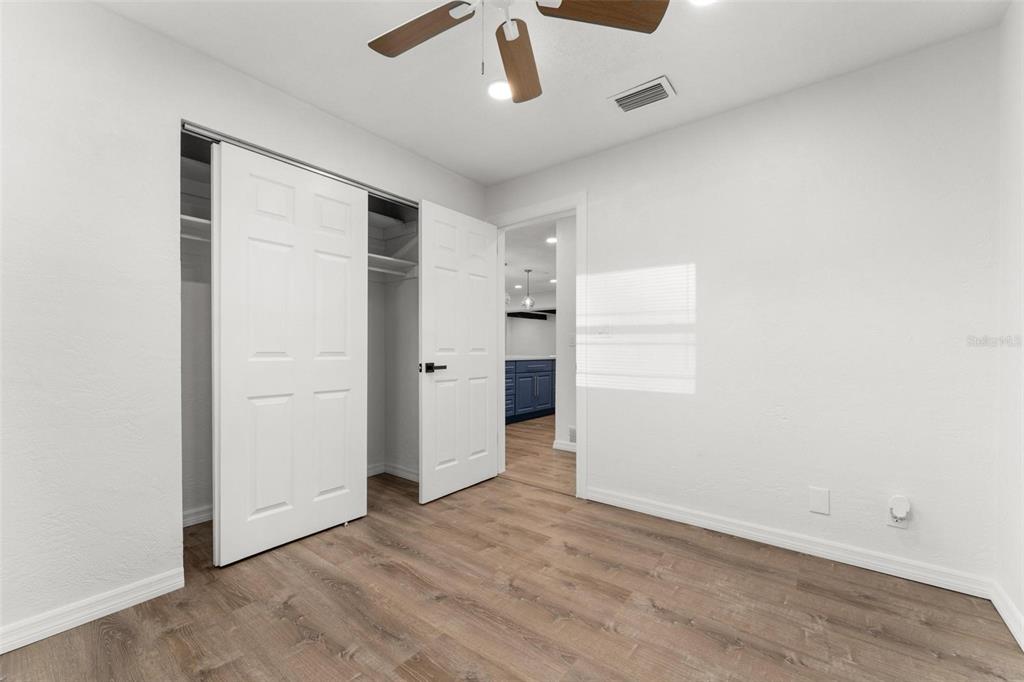 2203 Nottingham Road South Daytona, FL 32119 - Photo 33 of 40 an empty room with wooden floor and cabinet