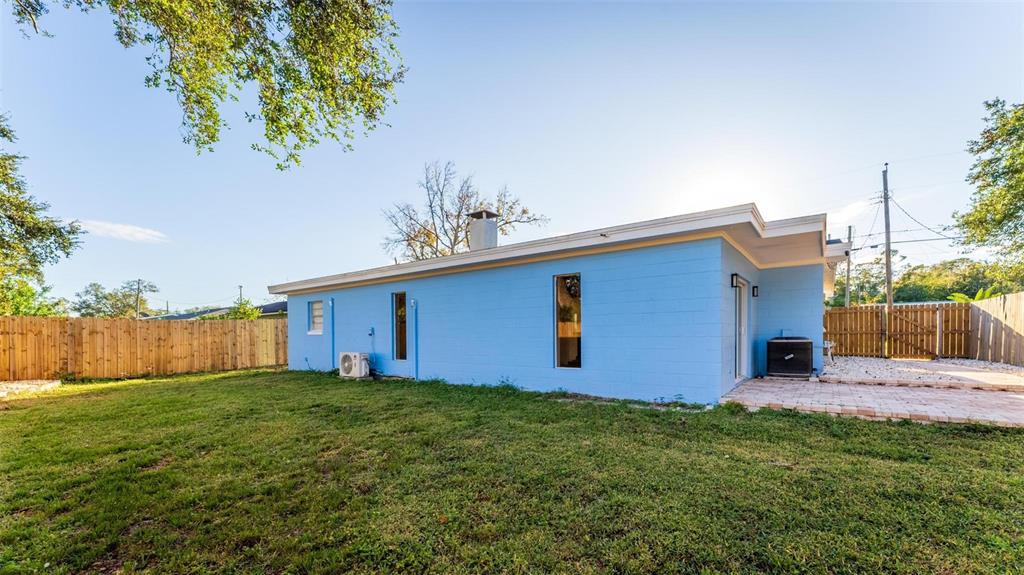 2203 Nottingham Road South Daytona, FL 32119 - Photo 38 of 40 a backyard of a house with lots of green space and fountain