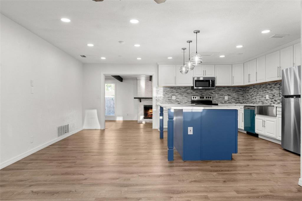 2203 Nottingham Road South Daytona, FL 32119 - Photo 9 of 40 a kitchen with stainless steel appliances granite countertop a stove a sink a refrigerator and a island