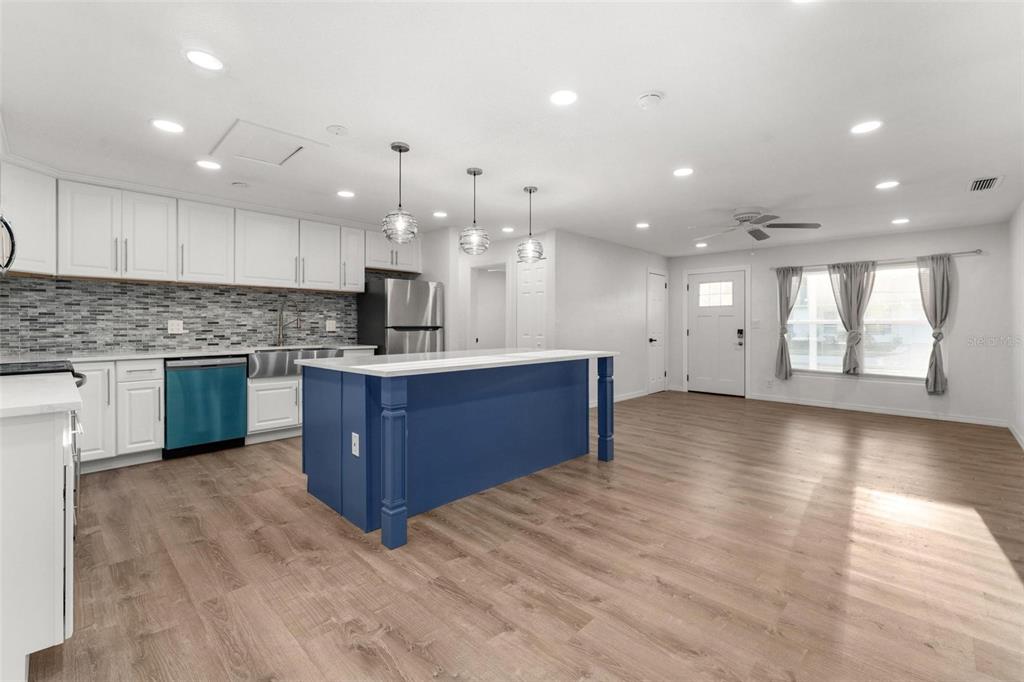 2203 Nottingham Road South Daytona, FL 32119 - Photo 10 of 40 a kitchen with stainless steel appliances granite countertop a large counter top a sink and a stove