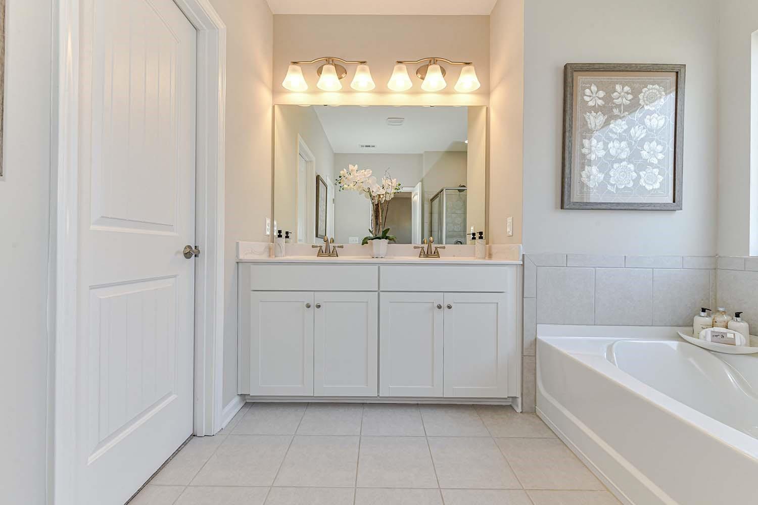 277 Harrison Lane Locust, NC 28097 - Photo 15 of 25 a spacious bathroom with a double vanity sink mirror and bathtub