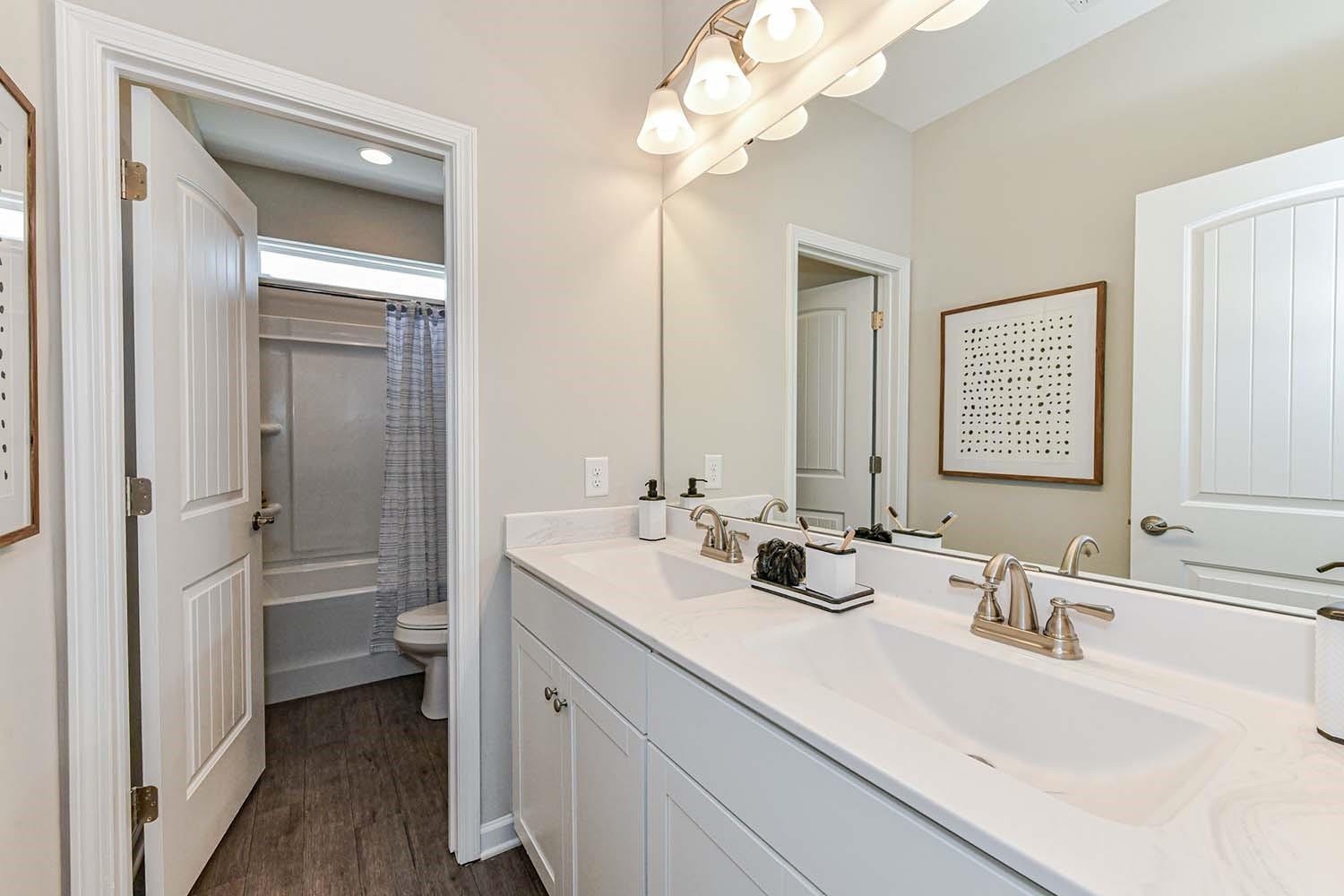 277 Harrison Lane Locust, NC 28097 - Photo 18 of 25 a bathroom with a double vanity sink mirror and toilet