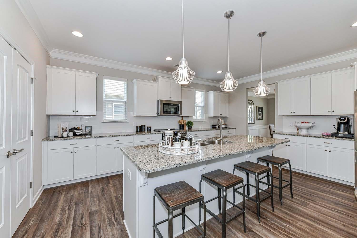 277 Harrison Lane Locust, NC 28097 - Photo 7 of 25 a kitchen with kitchen island granite countertop a sink a center island and cabinets