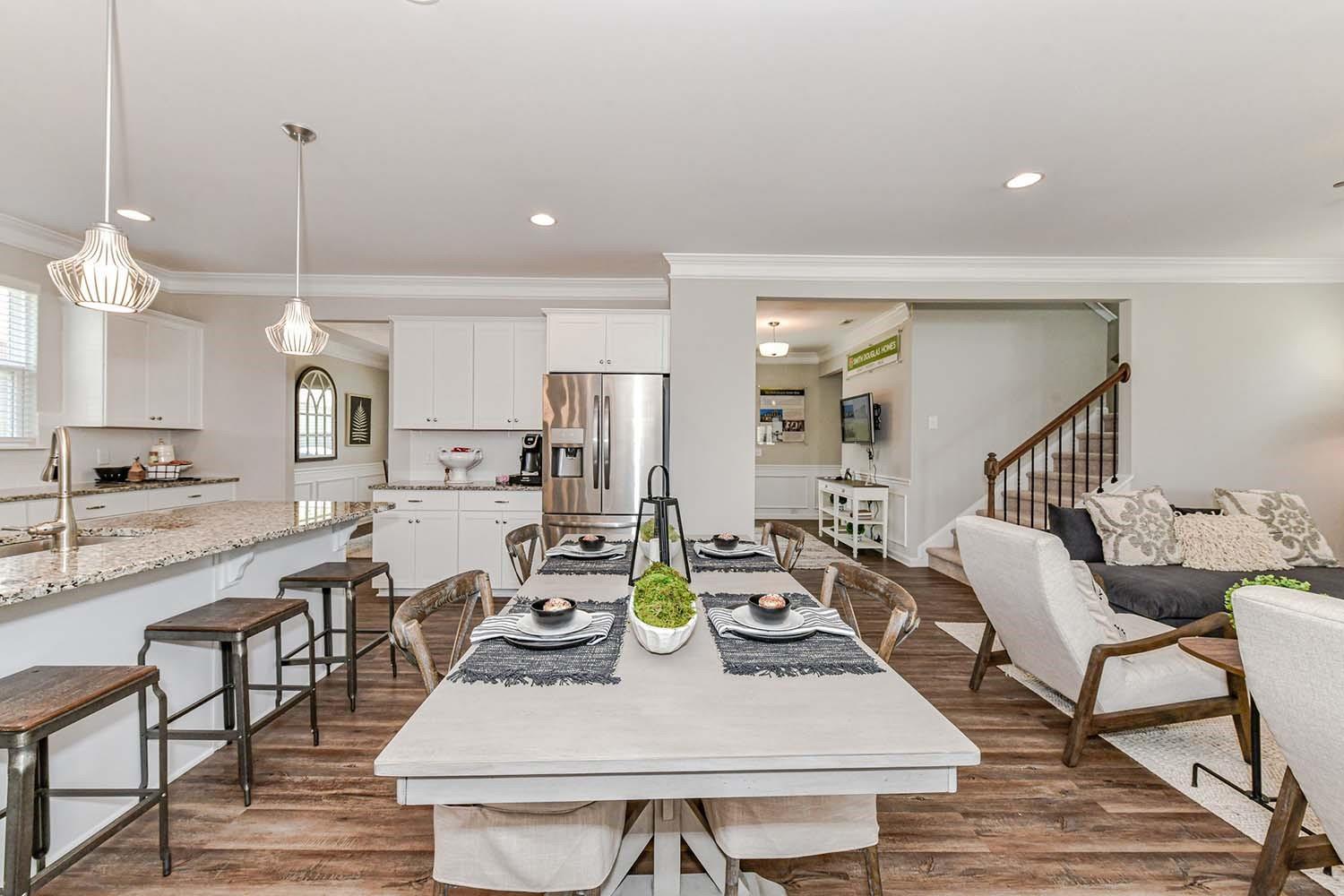 277 Harrison Lane Locust, NC 28097 - Photo 8 of 25 a view of a dining room with furniture a chandelier and wooden floor