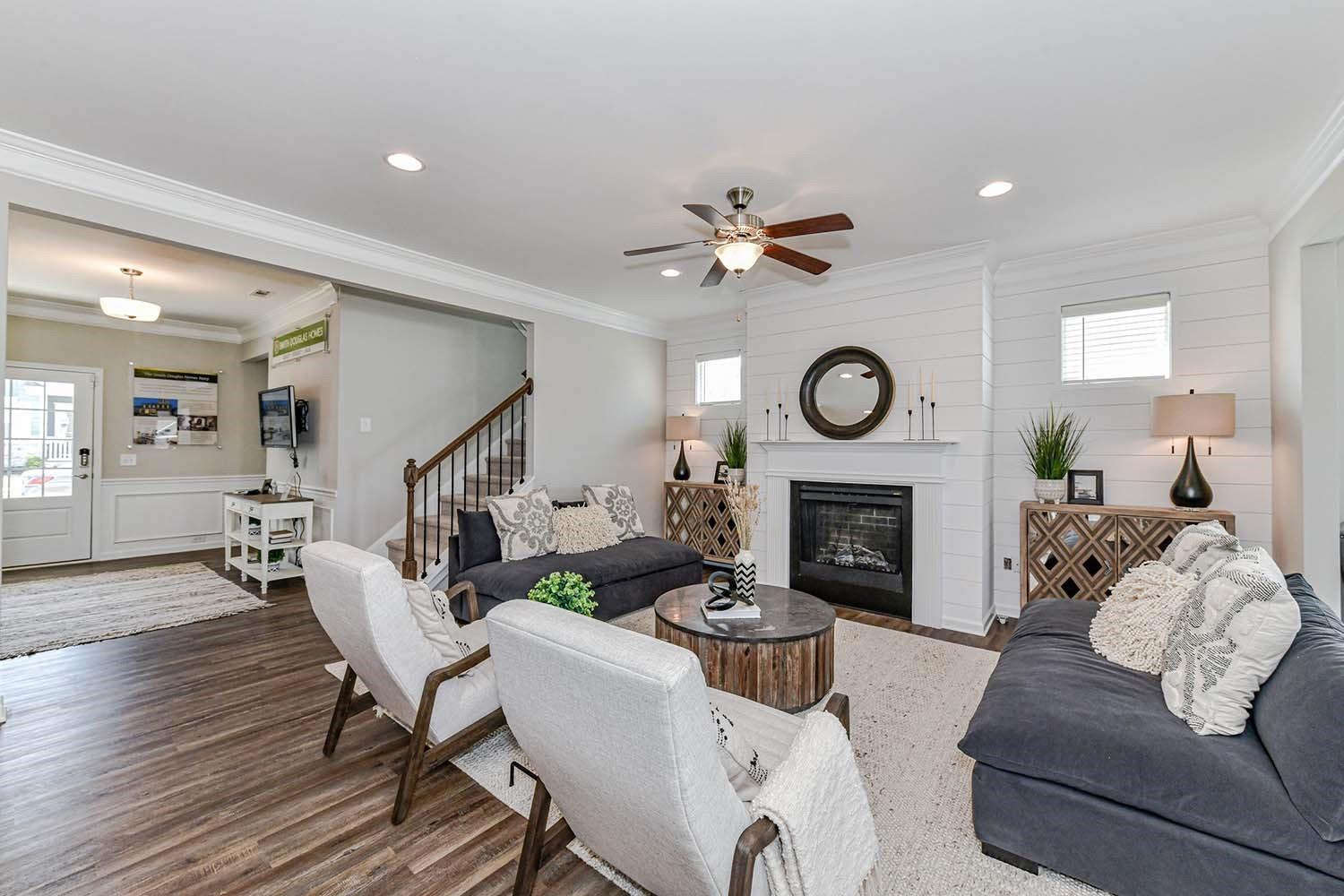 277 Harrison Lane Locust, NC 28097 - Photo 9 of 25 a living room with furniture a fireplace a rug and a window