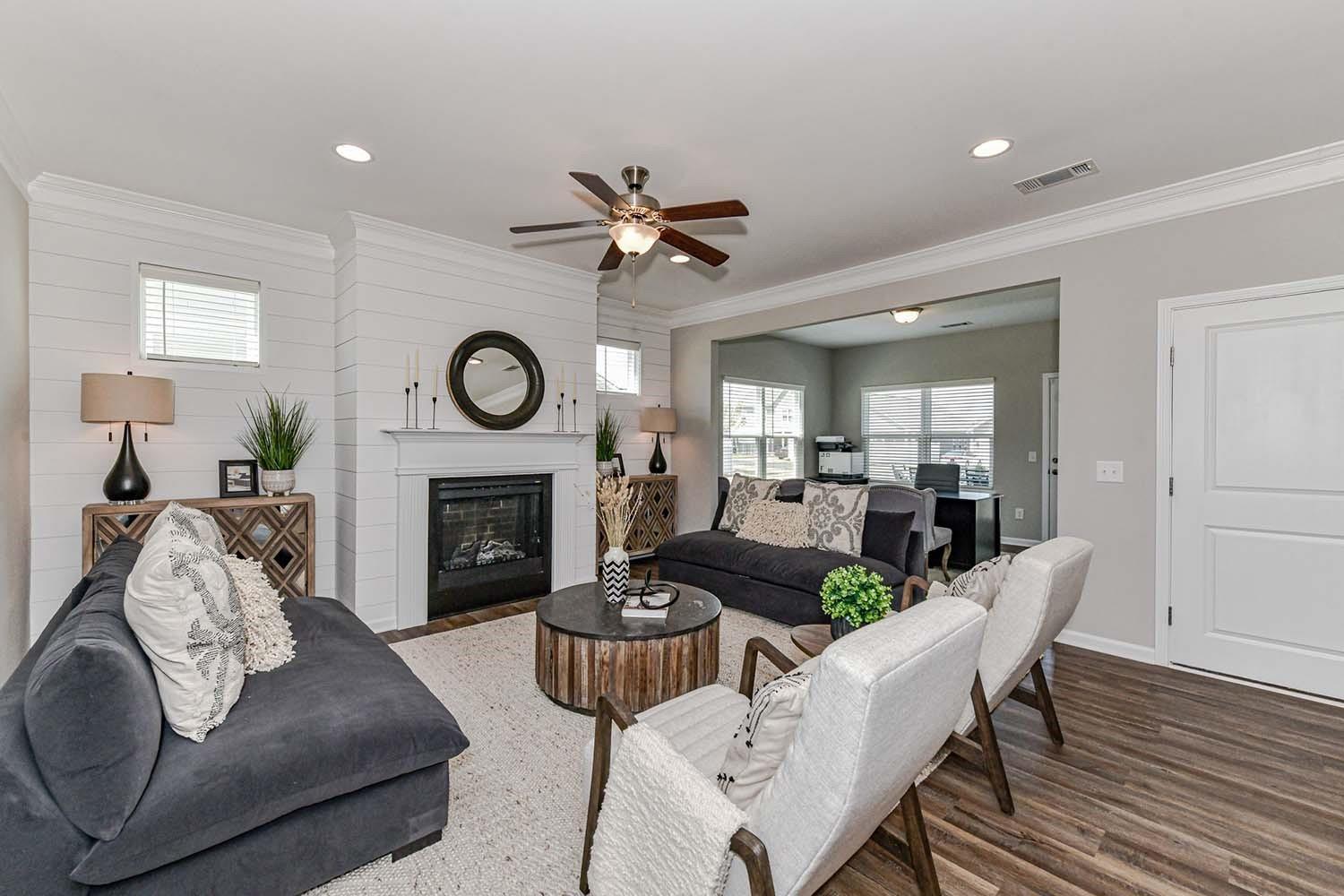 277 Harrison Lane Locust, NC 28097 - Photo 10 of 25 a living room with furniture a fireplace and wooden floor