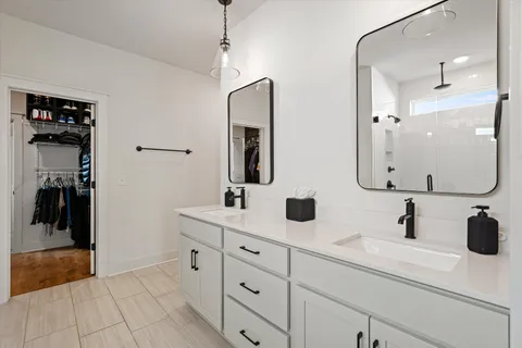 a bathroom with a double vanity sink mirror and