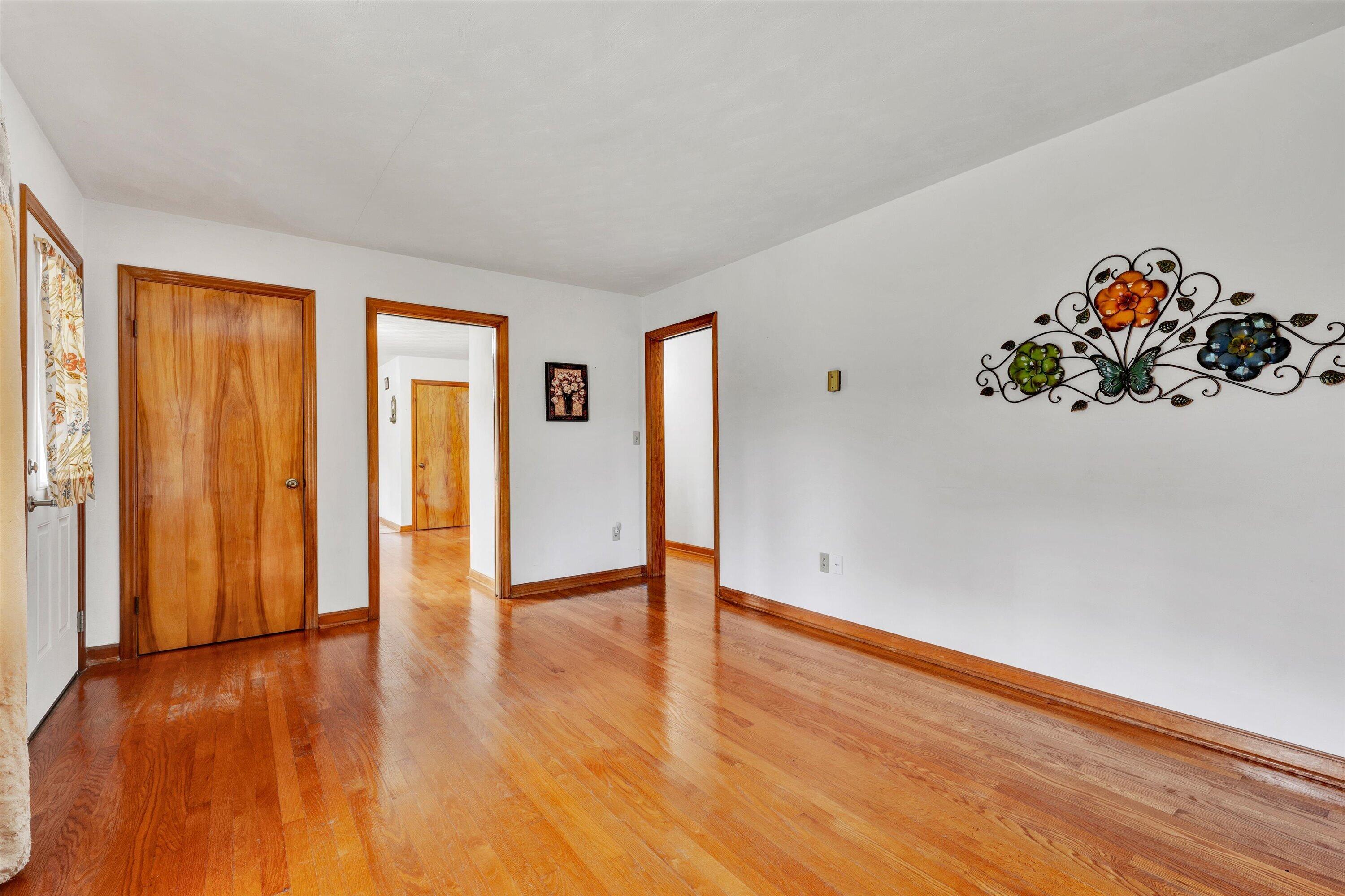 2296 Sandy Level Road Goodview, VA 24095 - Photo 12 of 48 a view of an empty room with wooden floor and a window