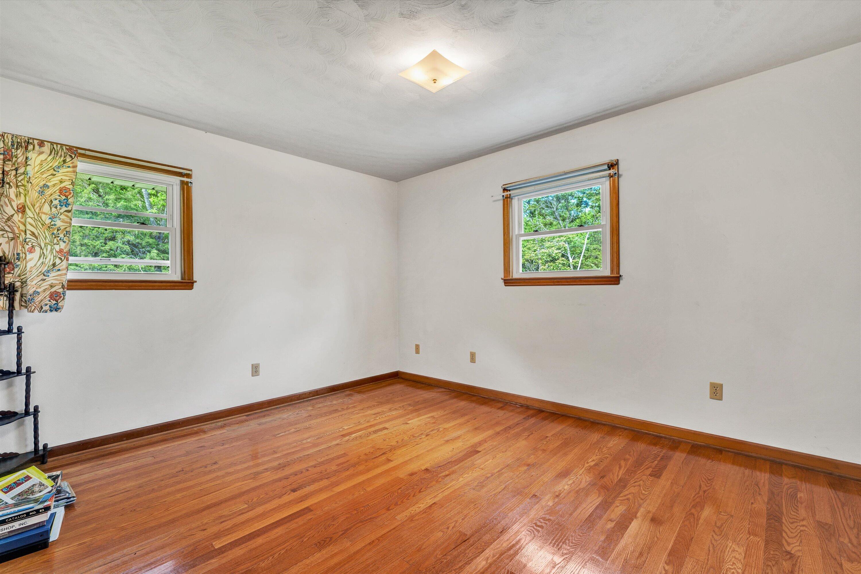 2296 Sandy Level Road Goodview, VA 24095 - Photo 17 of 48 a view of room with window and wooden floor