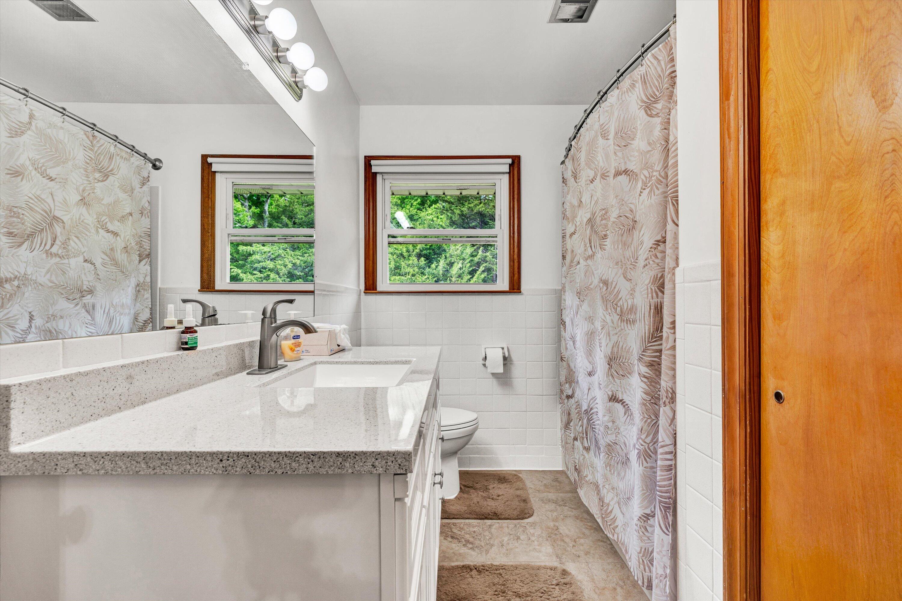 2296 Sandy Level Road Goodview, VA 24095 - Photo 22 of 48 a white bath tub sitting next to a white sink