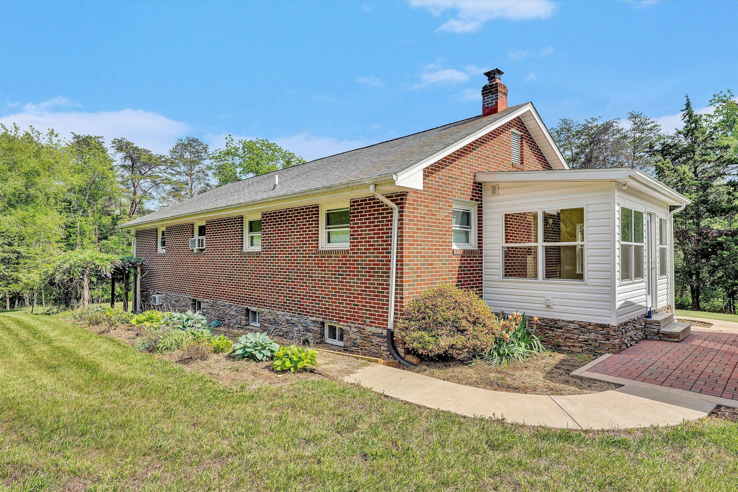2296 Sandy Level Road Goodview, VA 24095 - Photo 31 of 48 a front view of a house with garden