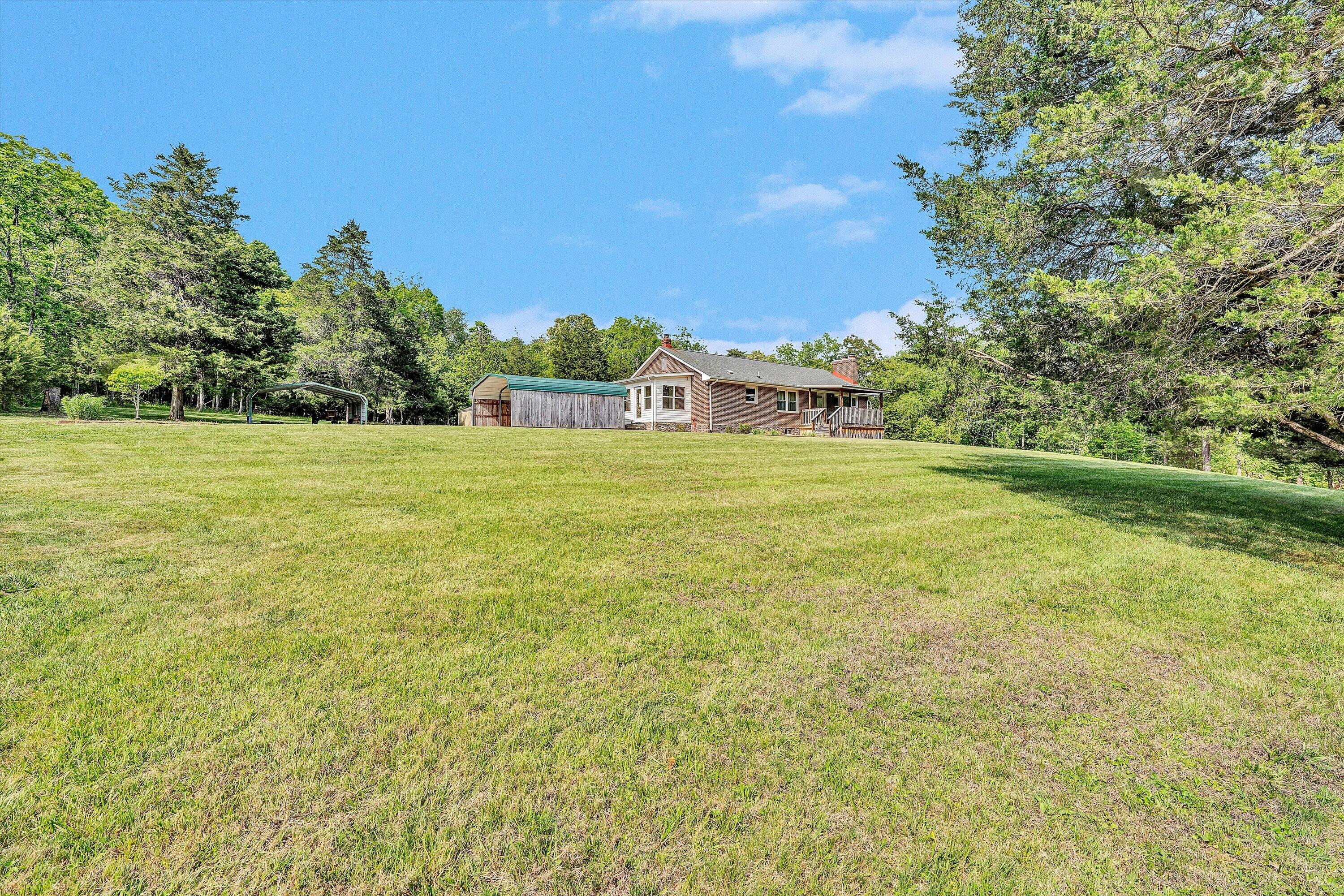 2296 Sandy Level Road Goodview, VA 24095 - Photo 40 of 48 a big yard with lots of green space and plants