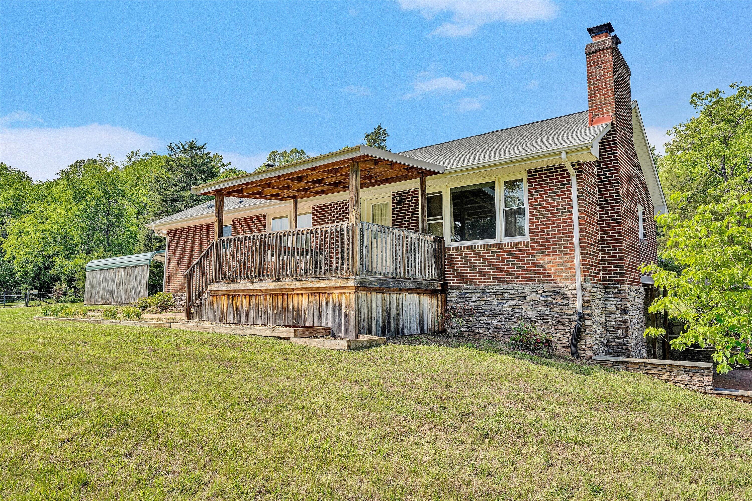2296 Sandy Level Road Goodview, VA 24095 - Photo 5 of 48 a front view of a house with a garden