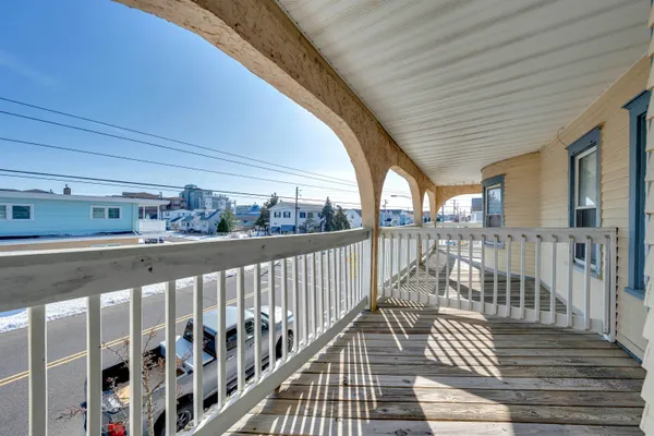 a view of a balcony with wooden floor