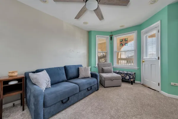 a living room with furniture and kitchen view