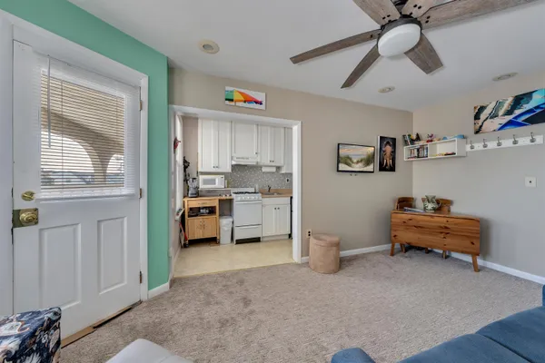 a kitchen with white cabinets and appliances