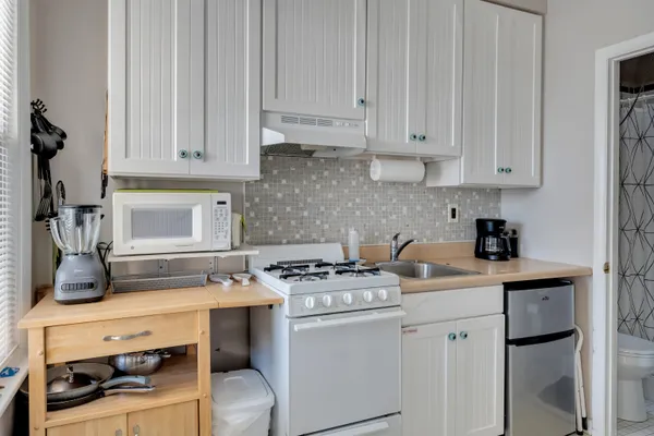 a kitchen with a stove and a refrigerator