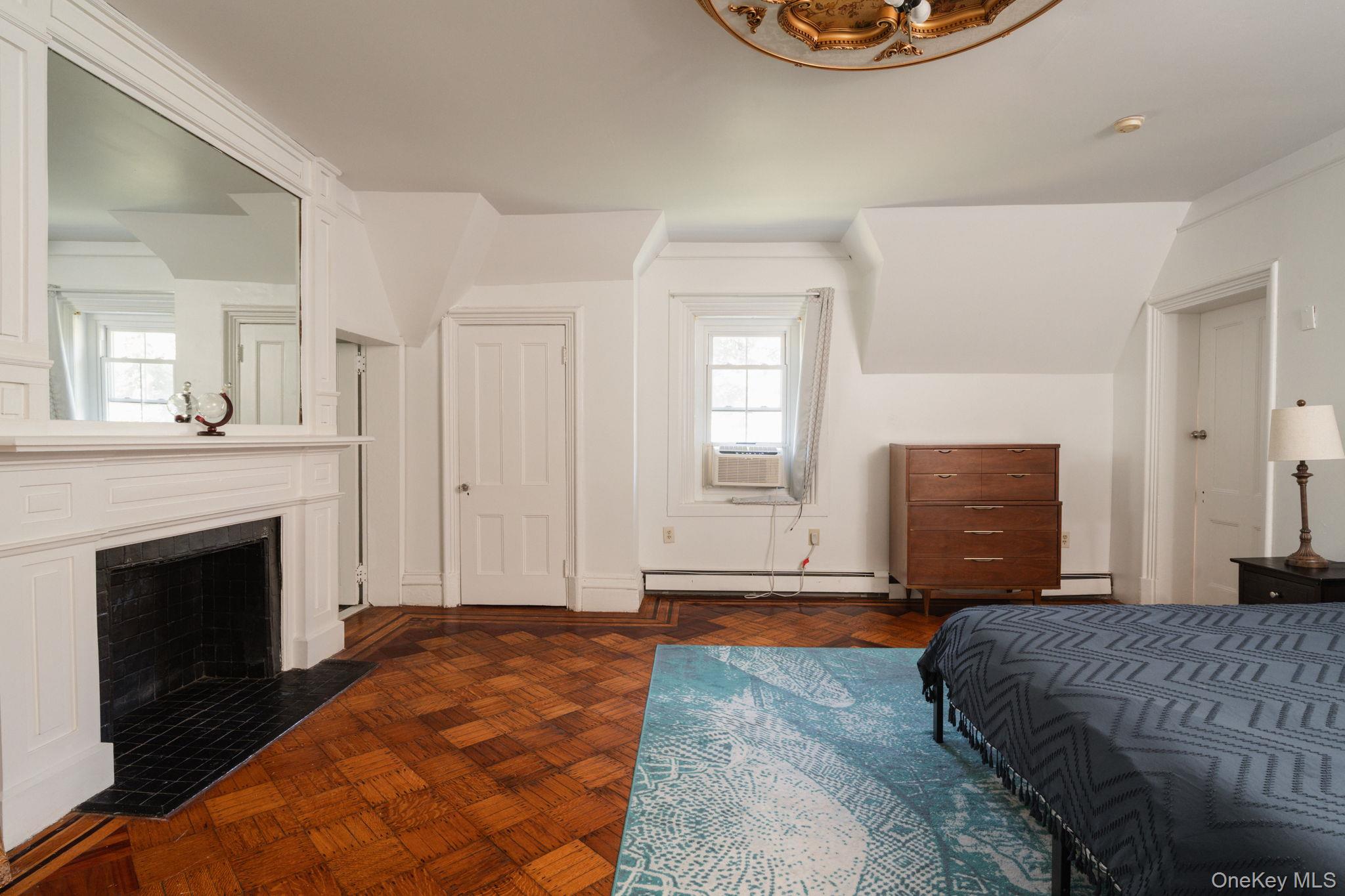 12 Monell Place Beacon, NY 12508 - Photo 20 of 27 a bedroom with a bed and a fireplace