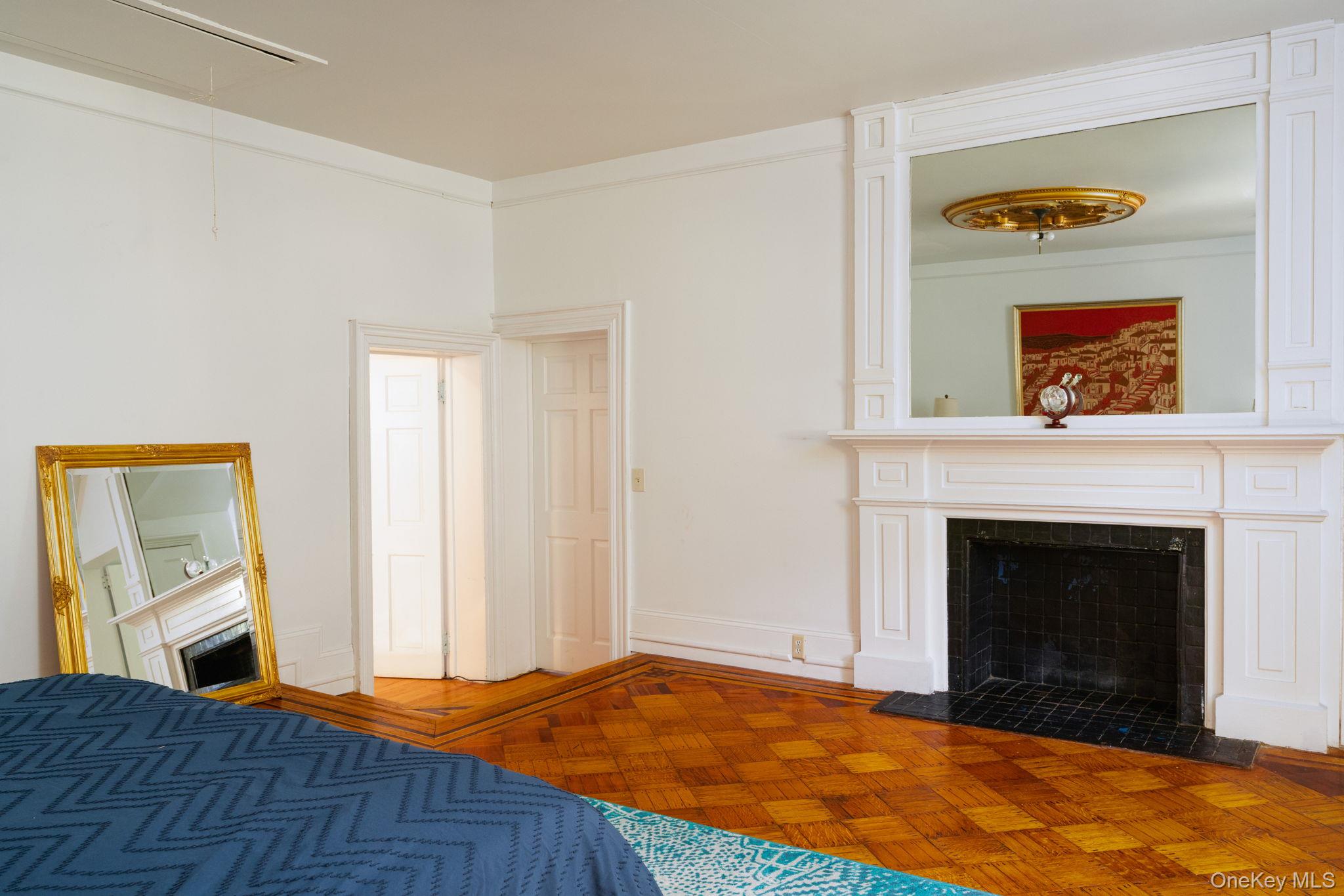 12 Monell Place Beacon, NY 12508 - Photo 21 of 27 a bedroom with a bed and a fireplace