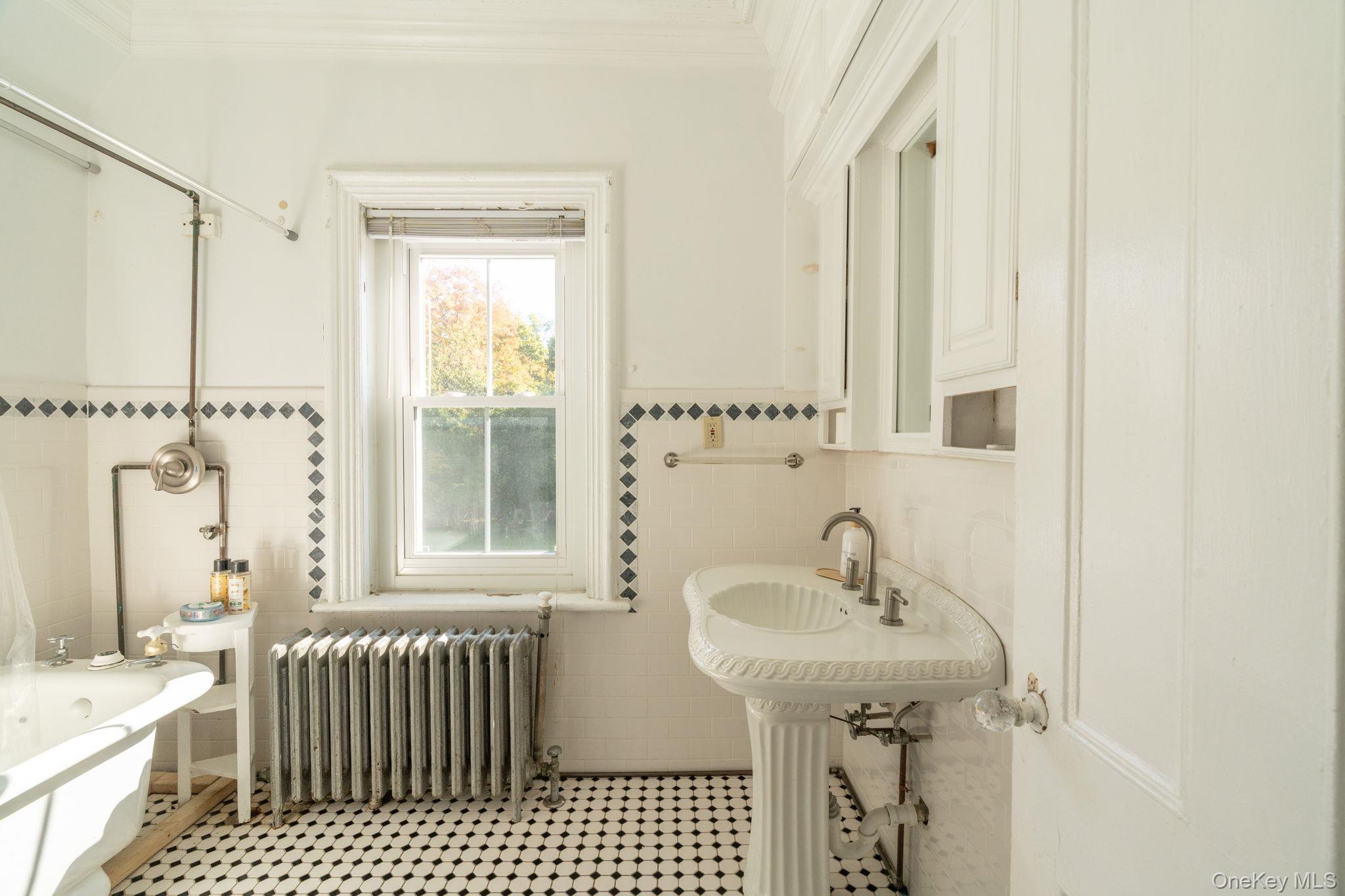 12 Monell Place Beacon, NY 12508 - Photo 24 of 27 a bathroom with a sink a mirror and a shower