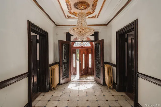 a living room with furniture a chandelier and a fireplace