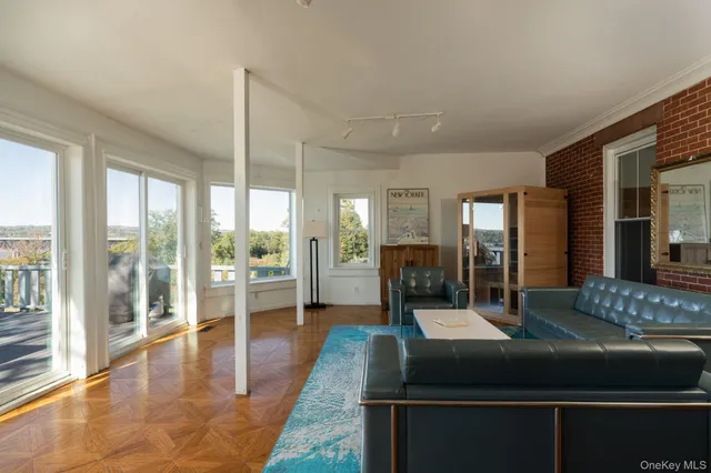 a view of hall with living room and floor to ceiling window
