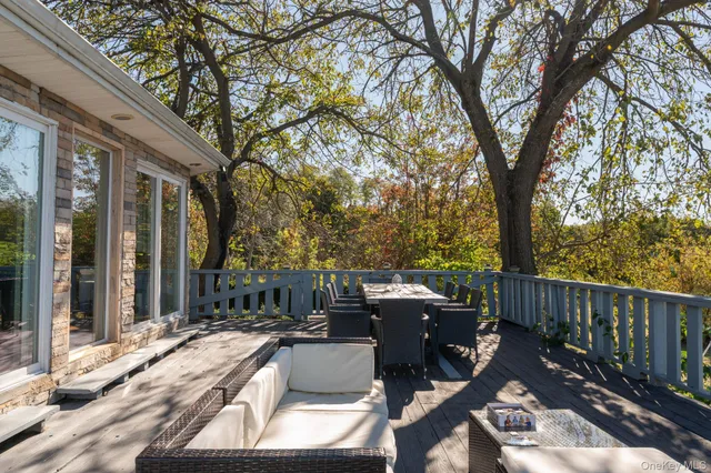 a view of a roof deck with wooden floor and fence