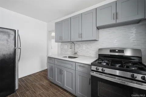a kitchen with stainless steel appliances a stove a refrigerator and cabinets