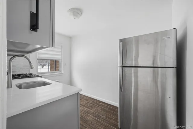 a kitchen with a refrigerator and a sink