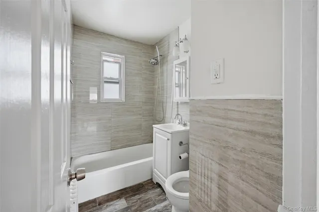 a bathroom with a toilet a sink and bathtub