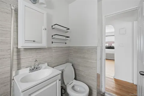 a bathroom with a toilet a sink and mirror