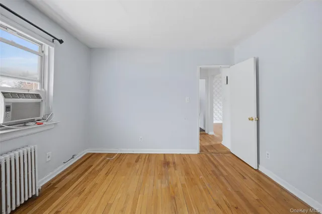 a view of a room with wooden floor and a window