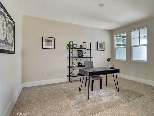 a dining room with furniture a chandelier and wooden floor