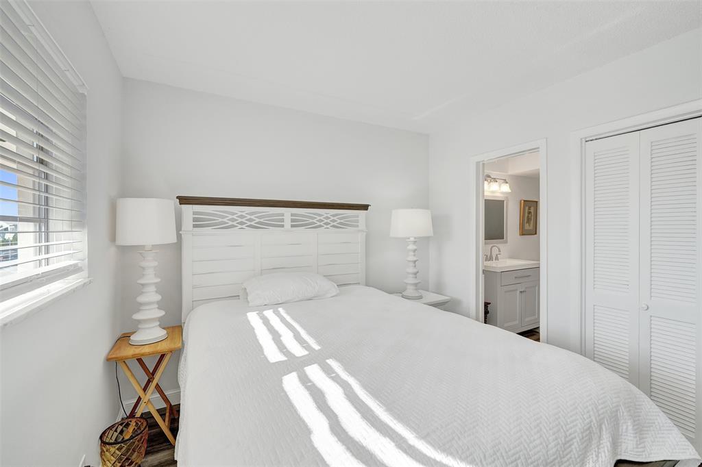 2751 East Golf Boulevard, Unit 2019 Pompano Beach, FL 33064 - Photo 11 of 68 a bedroom with a large bed and a window