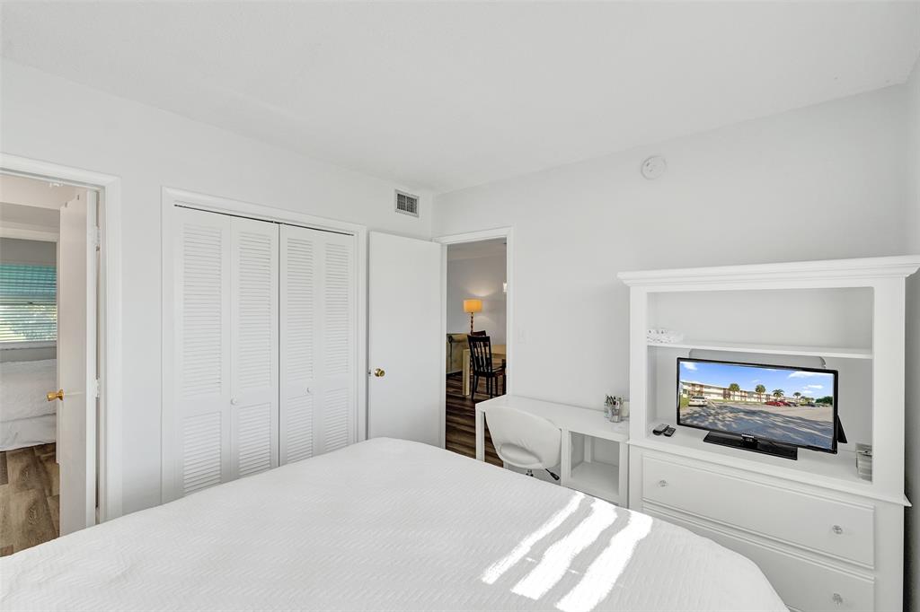 2751 East Golf Boulevard, Unit 2019 Pompano Beach, FL 33064 - Photo 12 of 68 a bedroom with a bed and a flat screen tv