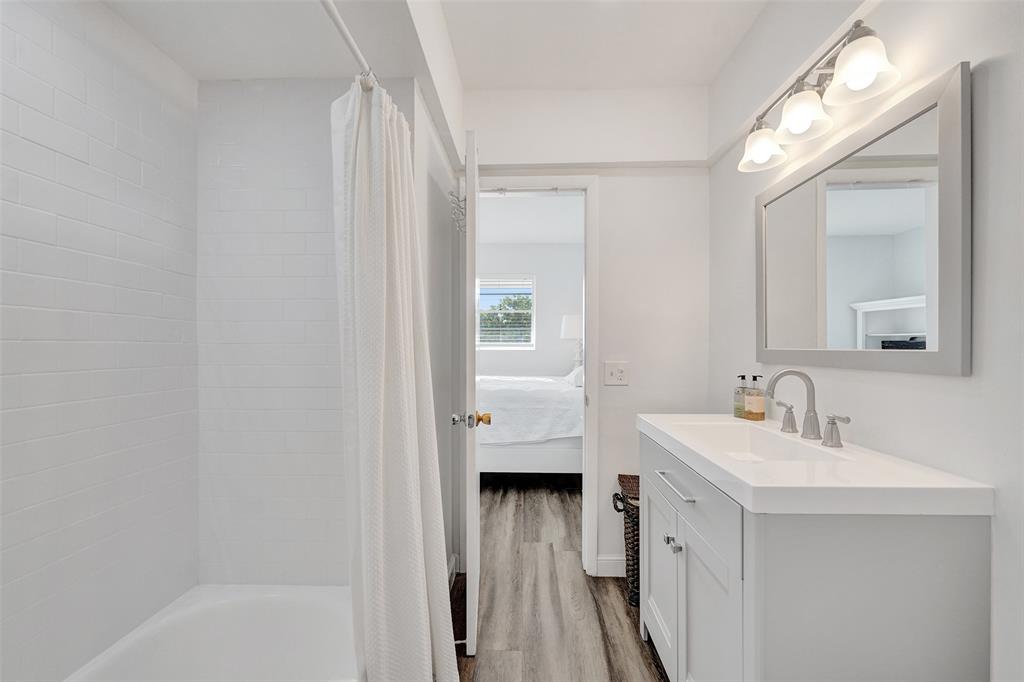 2751 East Golf Boulevard, Unit 2019 Pompano Beach, FL 33064 - Photo 13 of 68 a bathroom with a sink a mirror and a bathtub