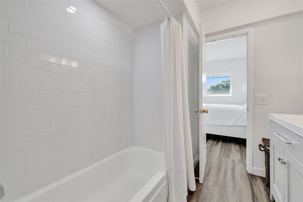 2751 East Golf Boulevard, Unit 2019 Pompano Beach, FL 33064 - Photo 14 of 68 a bathroom with a tub shower vanity and a sink