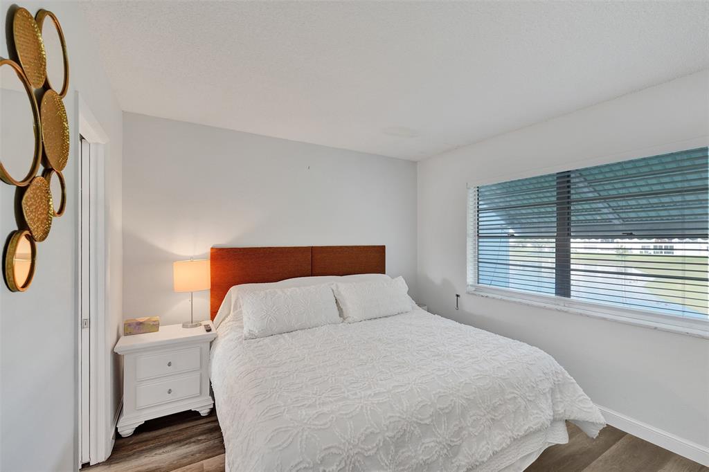 2751 East Golf Boulevard, Unit 2019 Pompano Beach, FL 33064 - Photo 16 of 68 a bedroom with a large bed and a window
