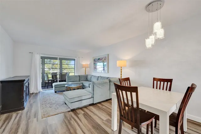 a living room with furniture and kitchen view